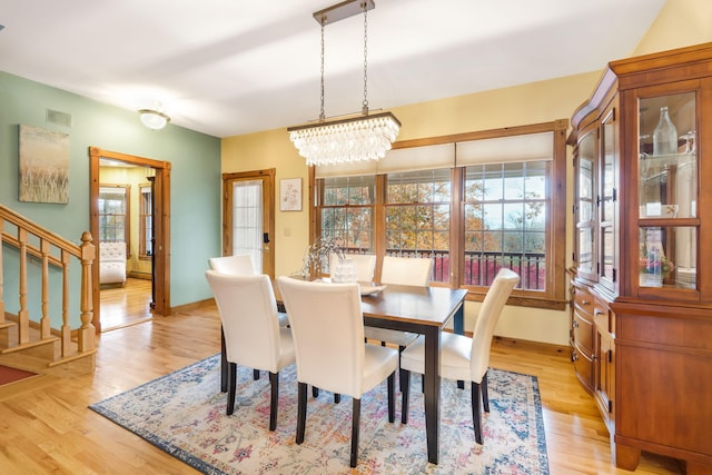 dining room featuring light hardwood / wood-style flooring and a chandelier