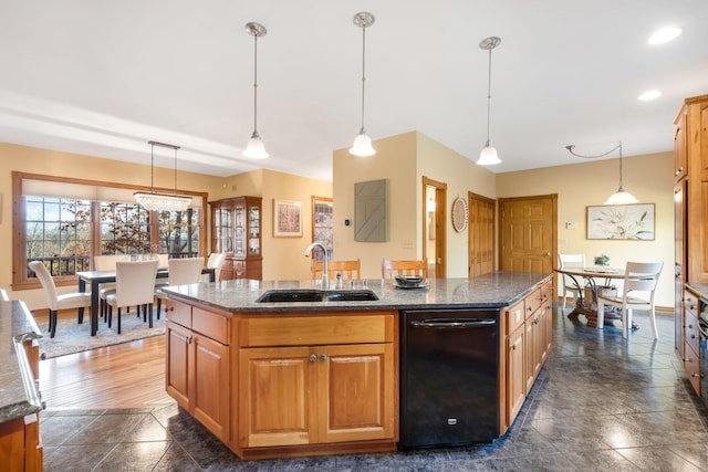 kitchen with sink, an island with sink, and hanging light fixtures