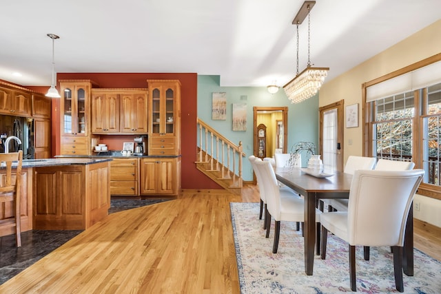 dining area featuring a chandelier, sink, and light wood-type flooring