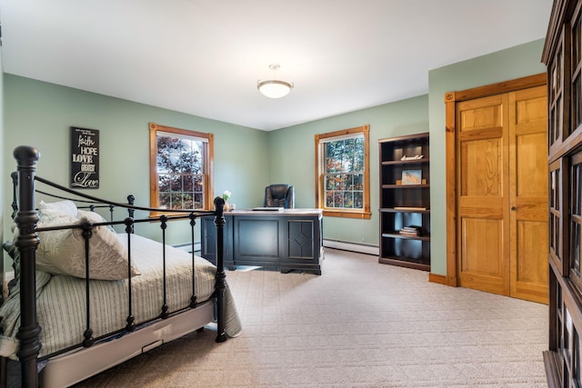 carpeted bedroom featuring a baseboard heating unit