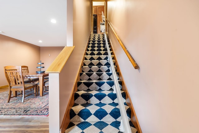 staircase featuring wood-type flooring