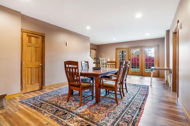 dining space with french doors and hardwood / wood-style flooring