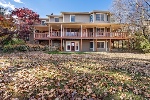 rear view of house featuring french doors and a wooden deck