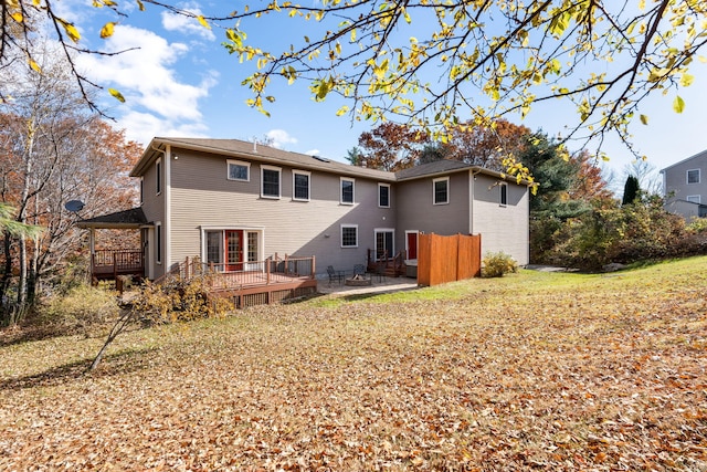 back of house with a deck and a patio area