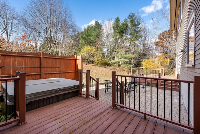 wooden terrace featuring a covered hot tub