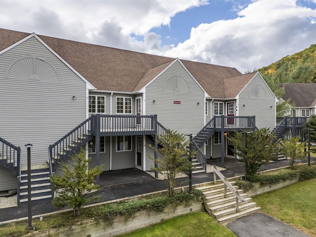 rear view of property with a wooden deck