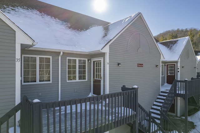 back of house featuring a wooden deck