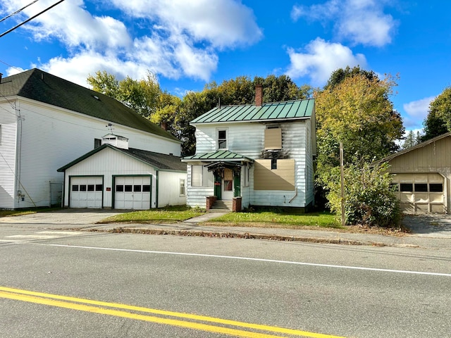 view of front of home featuring a garage and an outdoor structure