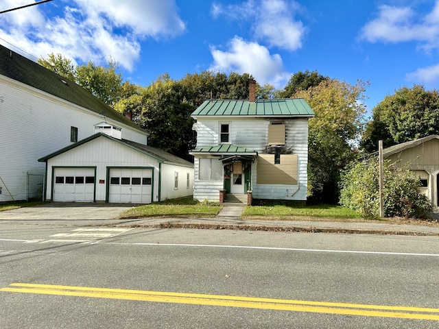 35 Roxbury Rd, Mexico, ME 04257 - traditional-style house with an outdoor structure, a chimney, a standing seam roof, metal roof, and a garage