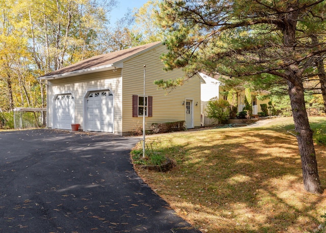 view of home's exterior featuring a garage and a lawn