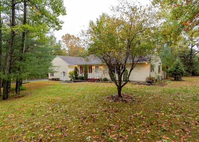 ranch-style house featuring a front yard and a garage