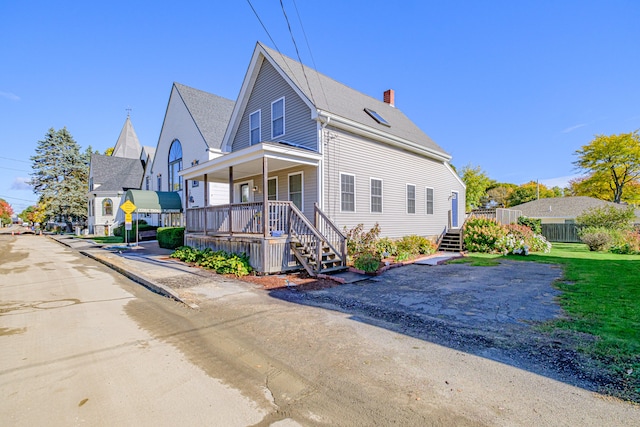 view of side of property with covered porch