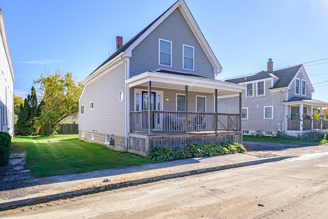 view of front of home featuring covered porch and a front lawn