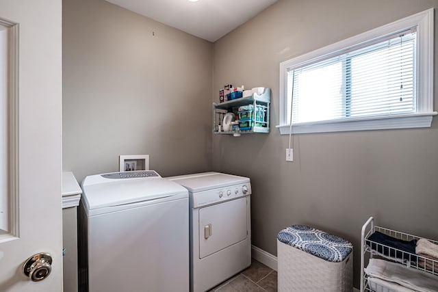 laundry area featuring light tile patterned floors and separate washer and dryer