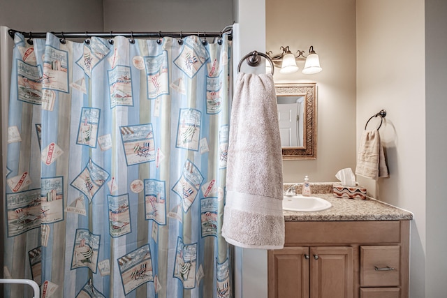 bathroom featuring a shower with curtain and vanity