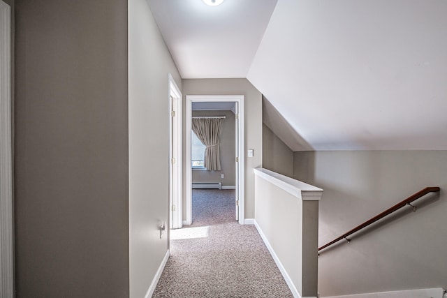 hallway featuring a baseboard radiator, vaulted ceiling, and light colored carpet