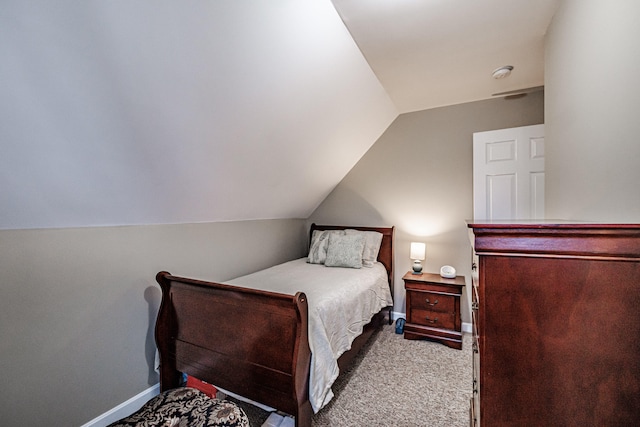 carpeted bedroom featuring lofted ceiling