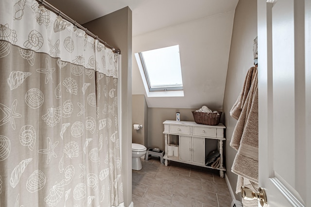 bathroom with toilet and a skylight