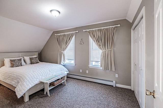 bedroom featuring carpet, a closet, vaulted ceiling, and baseboard heating