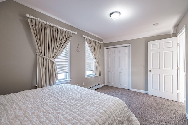 bedroom with carpet flooring, a baseboard heating unit, and a closet