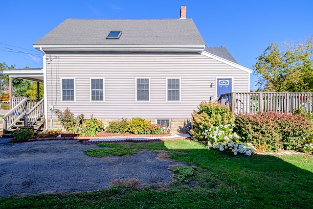 rear view of house with a lawn