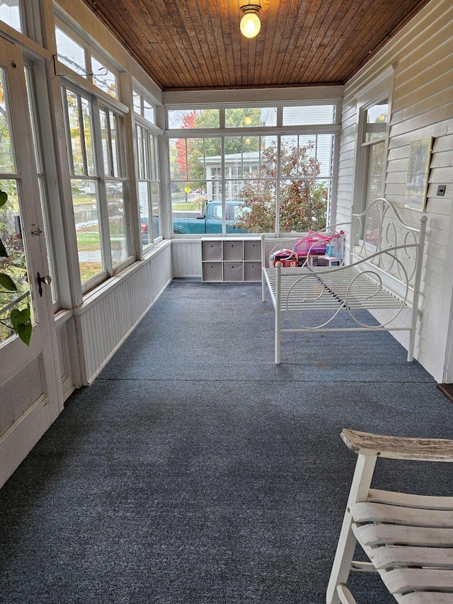 unfurnished sunroom with wood ceiling