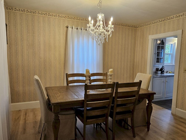 dining space with a notable chandelier and dark hardwood / wood-style floors