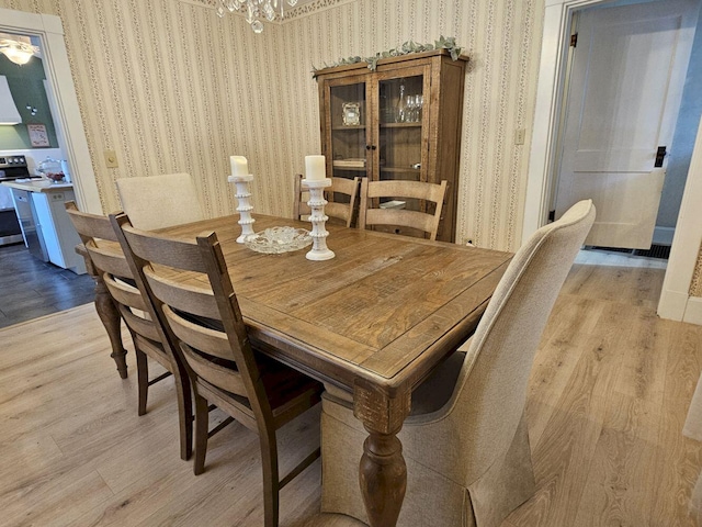 dining space featuring a notable chandelier and light hardwood / wood-style flooring