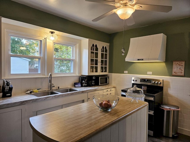 kitchen with stainless steel appliances, plenty of natural light, extractor fan, and sink