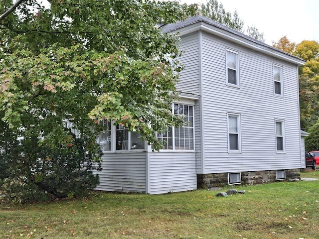 view of side of property with a yard