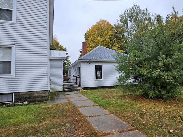 view of side of home with a lawn