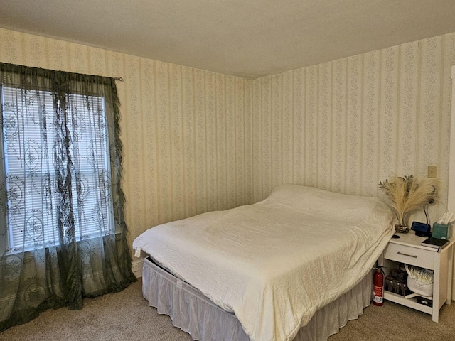 bedroom featuring multiple windows and carpet floors