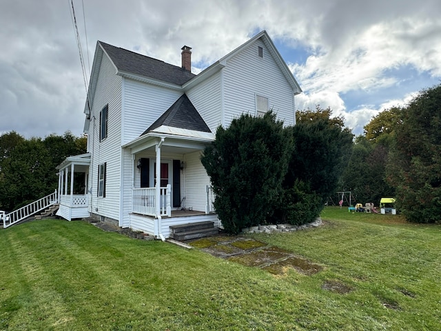 view of property exterior with covered porch and a lawn