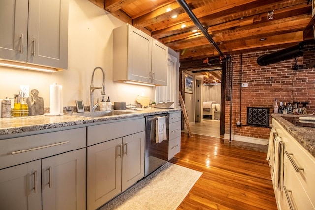 kitchen with sink, light wood-type flooring, dishwasher, wood ceiling, and beamed ceiling