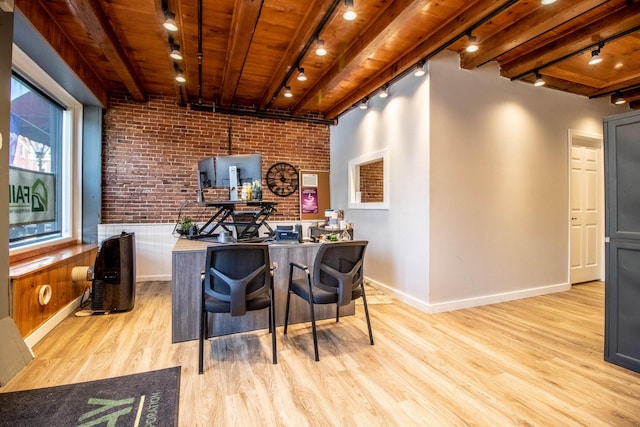 bar with beam ceiling, rail lighting, light wood-type flooring, and wood ceiling