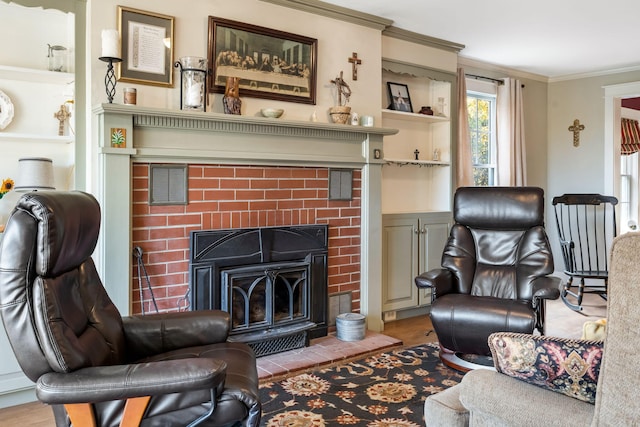 living room with crown molding, light hardwood / wood-style flooring, a brick fireplace, and built in shelves