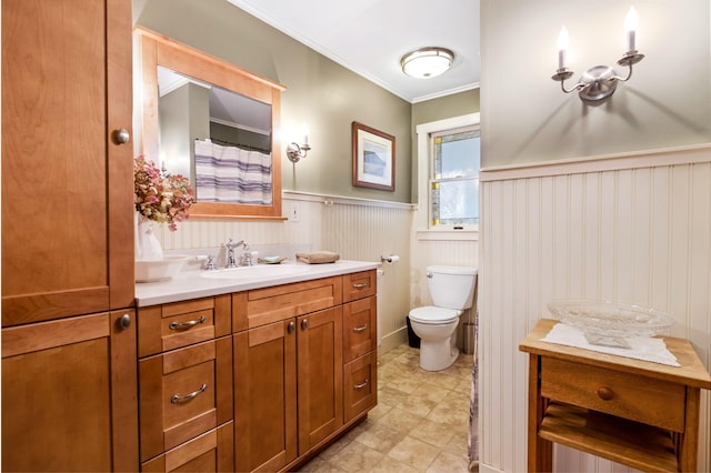 bathroom with vanity, ornamental molding, and toilet