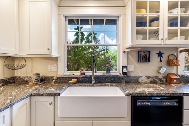 kitchen featuring white cabinetry, black dishwasher, sink, and dark stone counters