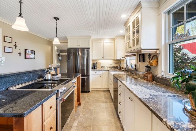 kitchen with hanging light fixtures, wooden ceiling, dark stone countertops, sink, and stainless steel appliances