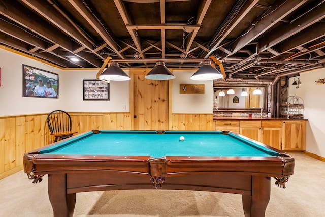 rec room with light colored carpet and wood walls