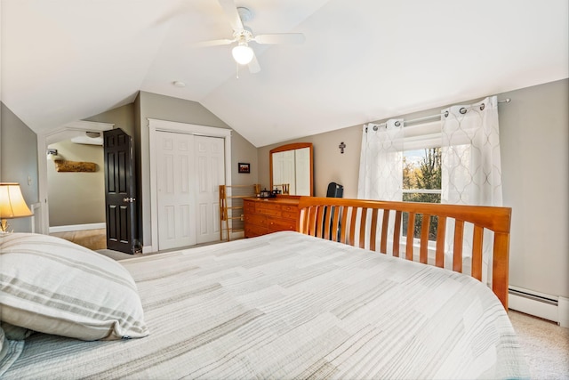 bedroom with lofted ceiling, a closet, carpet, a baseboard radiator, and ceiling fan