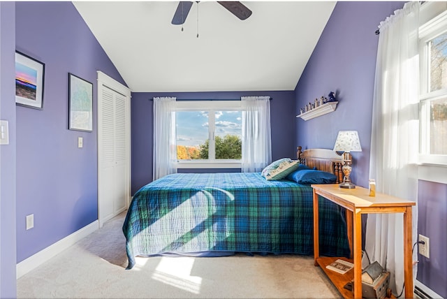 bedroom with light carpet, a closet, ceiling fan, and vaulted ceiling