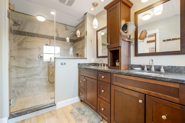 bathroom with vanity, hardwood / wood-style floors, and an enclosed shower