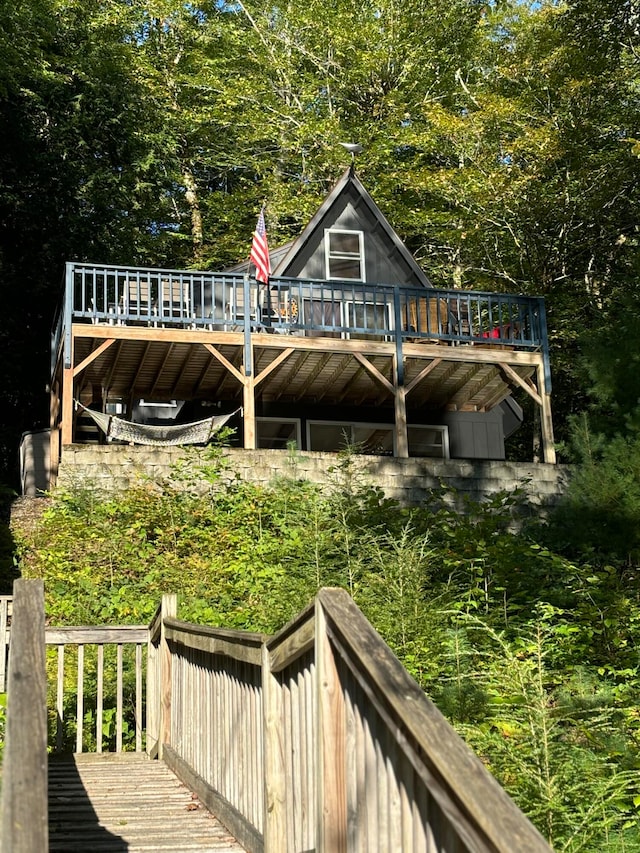 rear view of property with a wooden deck