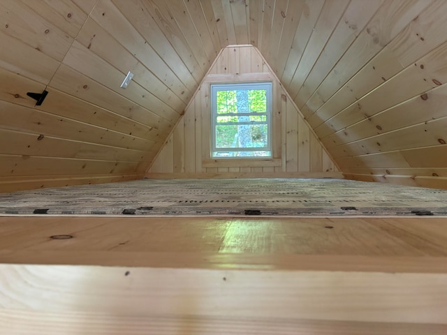 bonus room featuring lofted ceiling, wooden walls, and wooden ceiling