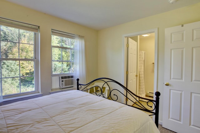 carpeted bedroom with cooling unit and baseboard heating