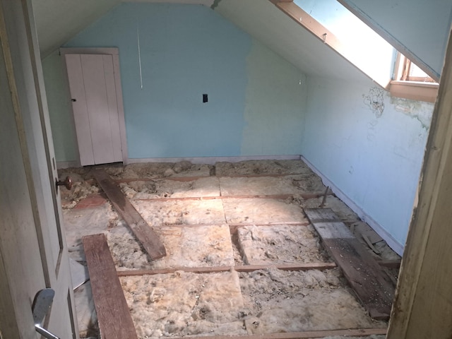 bonus room with vaulted ceiling with skylight