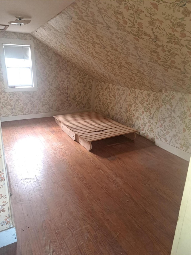 bonus room featuring wood-type flooring and vaulted ceiling