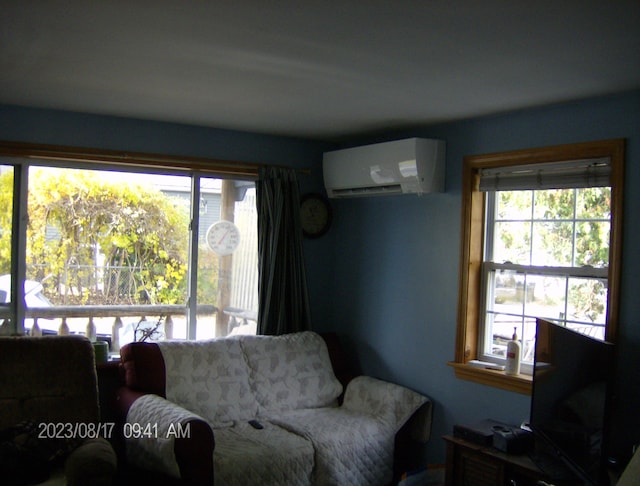 living room with a wall mounted air conditioner and a healthy amount of sunlight