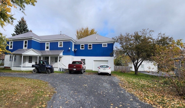 view of front property featuring a porch and a garage